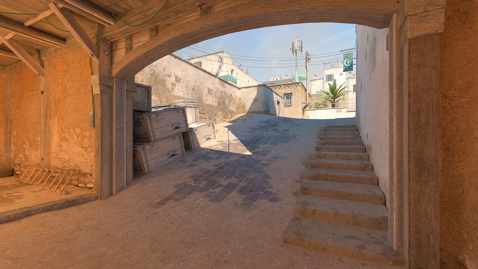 Counter-Strike 2 view up the CT ramp on Dust II, a sunlit stone stairway under an arch leading towards B site