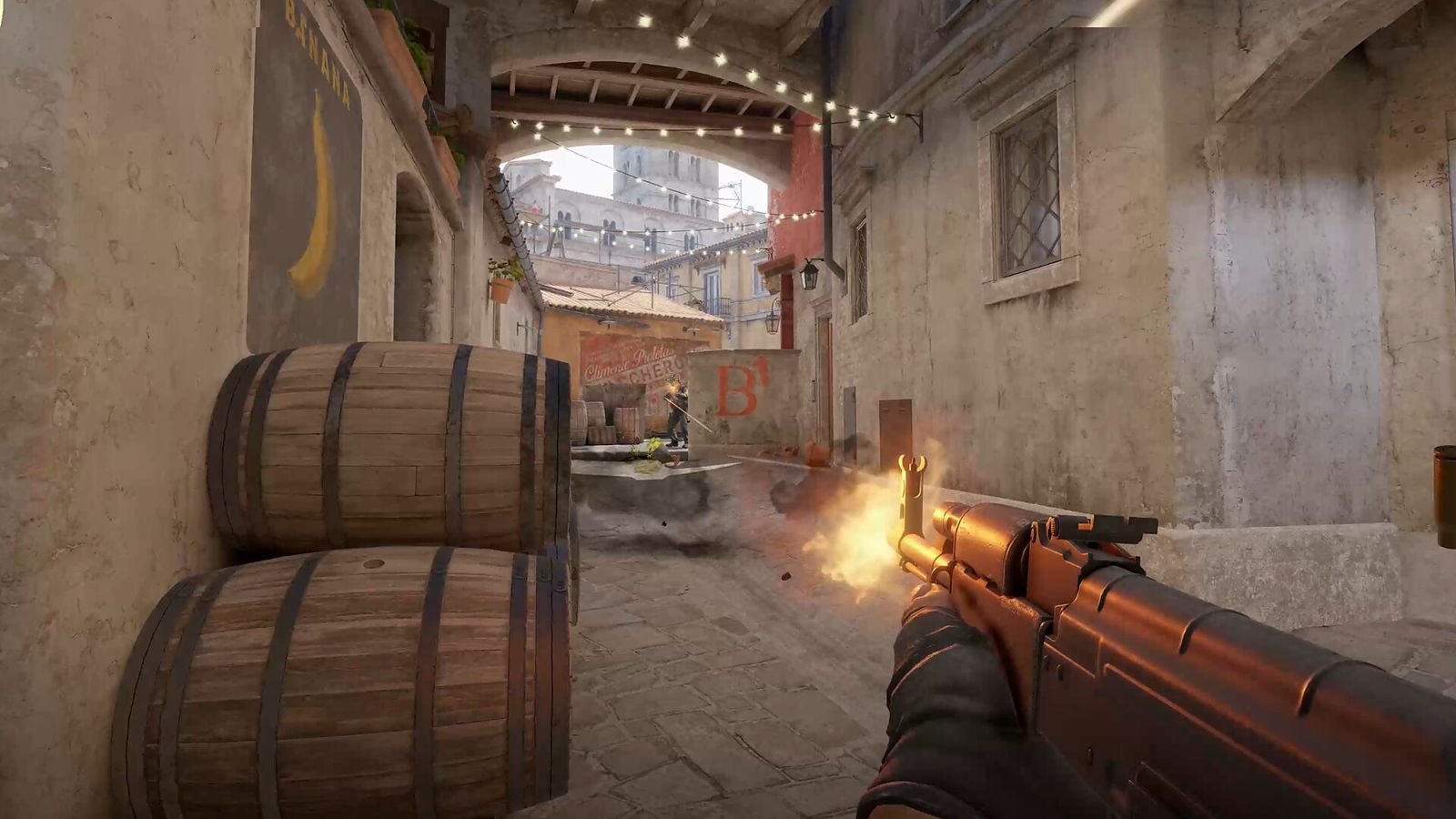 First-person view of an AK-47 on Inferno in CS2, looking down a narrow street