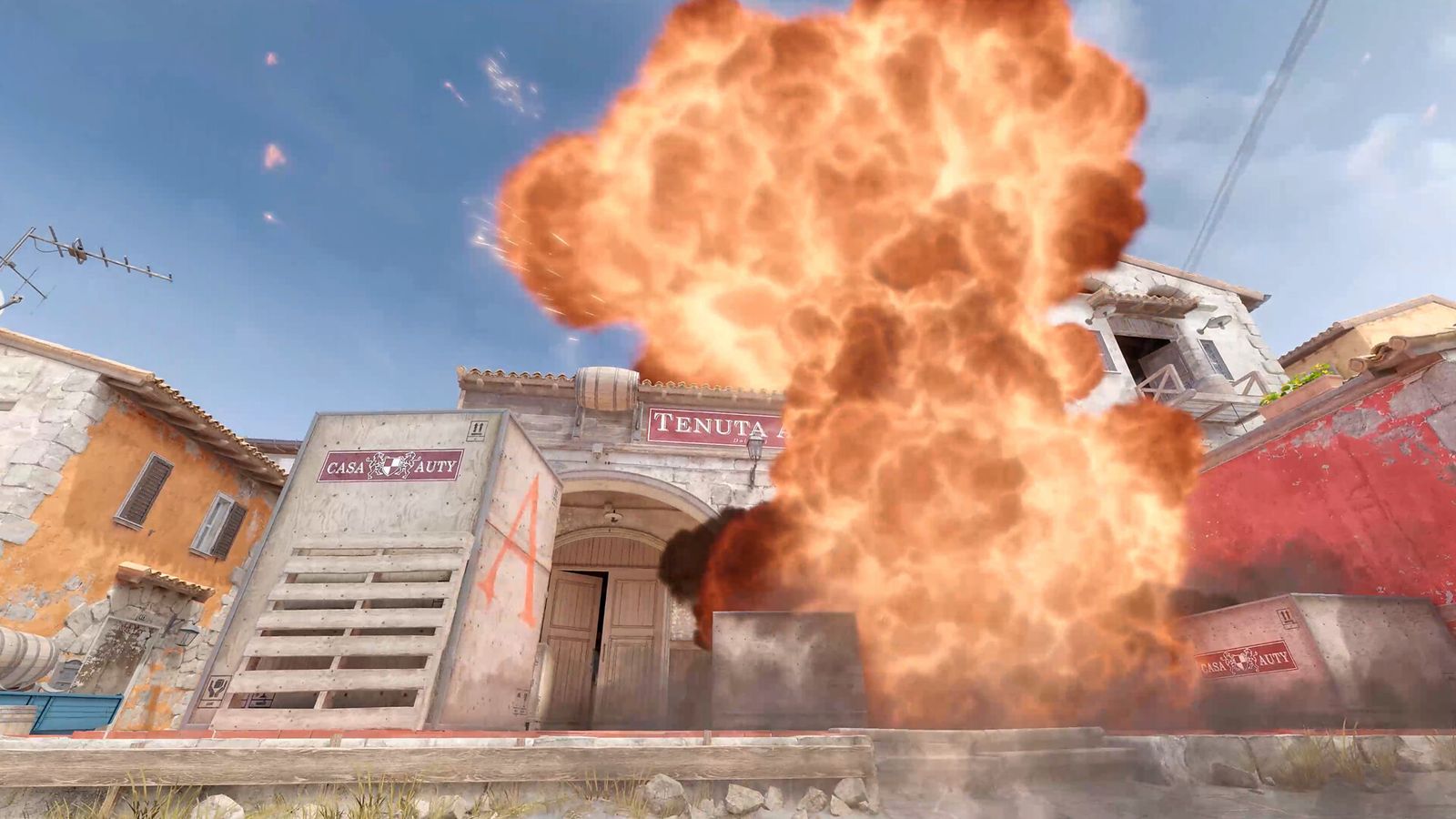 A grenade exploding on Inferno in CS2 as players take a bombsite