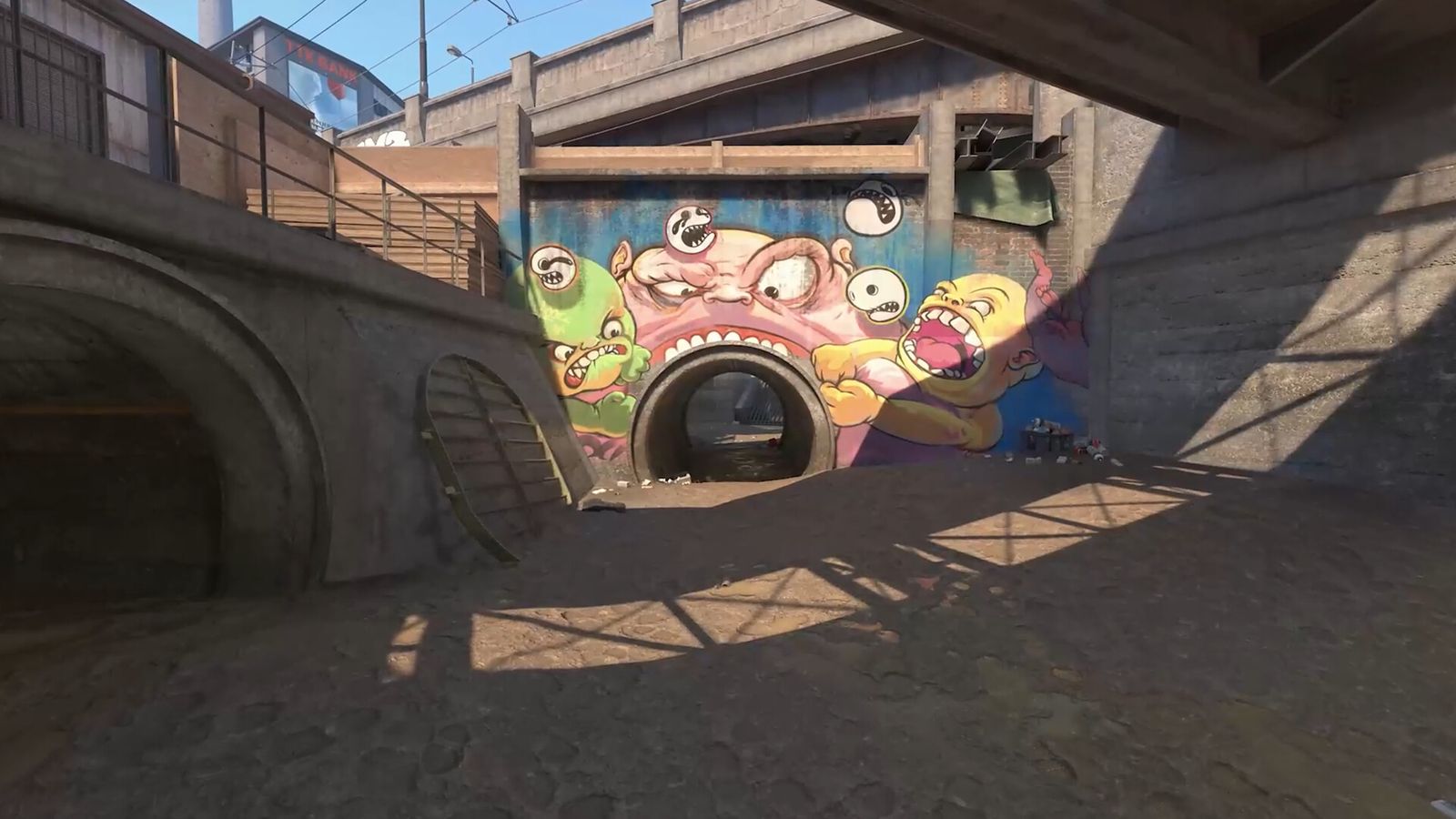Two CS2 players in front of the graffiti wall in the Overpass park