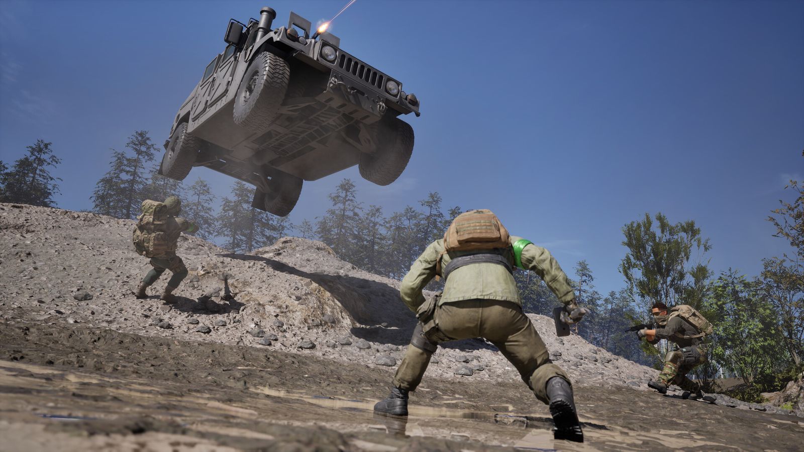 A WARDOGS armoured personnel carrier launching over a dirt ridge while infantry run alongside