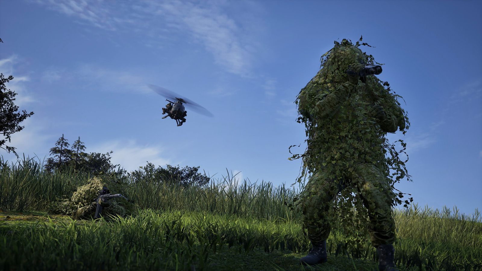 A WARDOGS Recon player in a ghillie suit glassing with binoculars in tall grass while a second sniper lies prone and a helicopter passes overhead