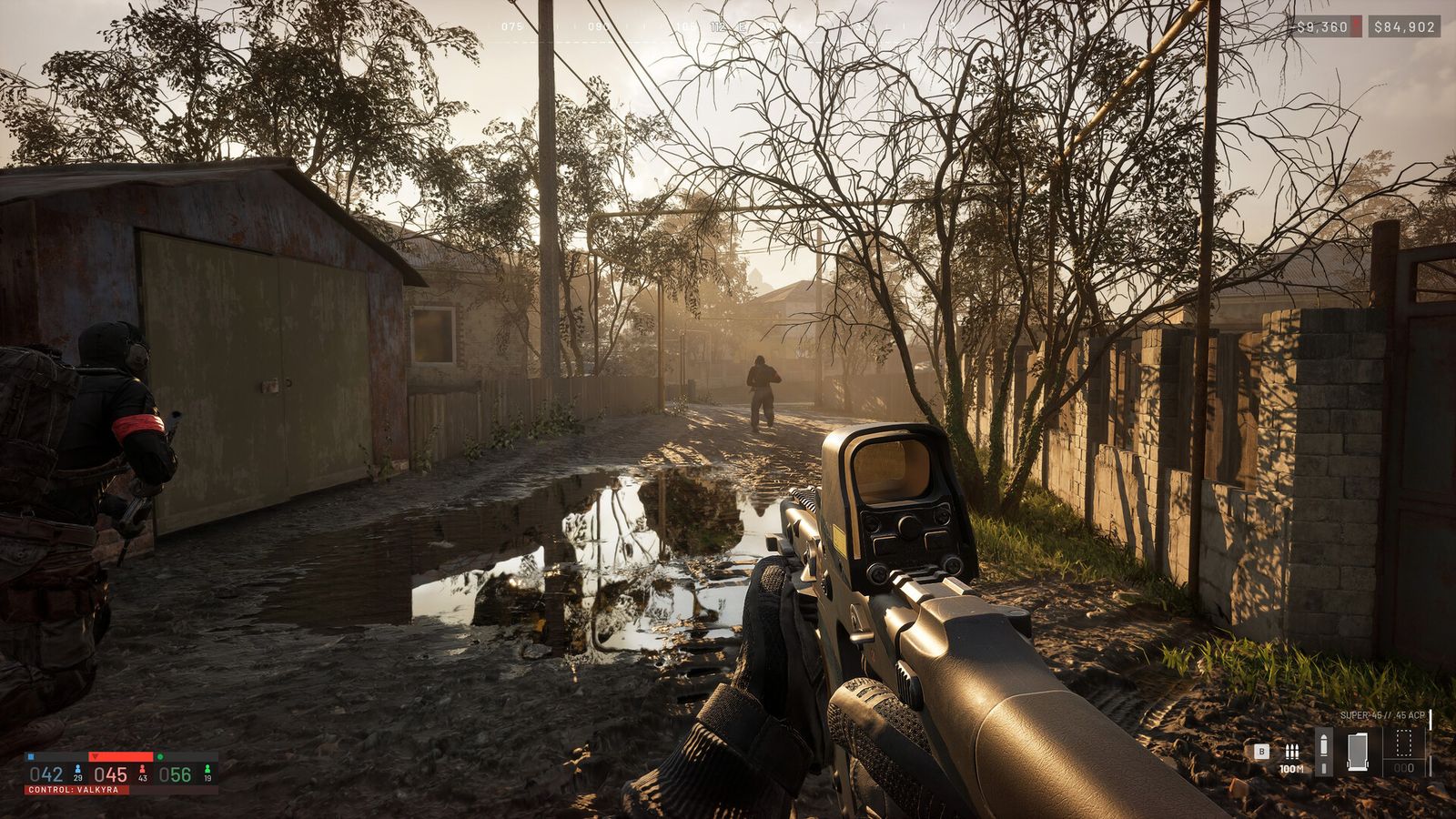 WARDOGS soldiers advancing down a village street past parked vehicles