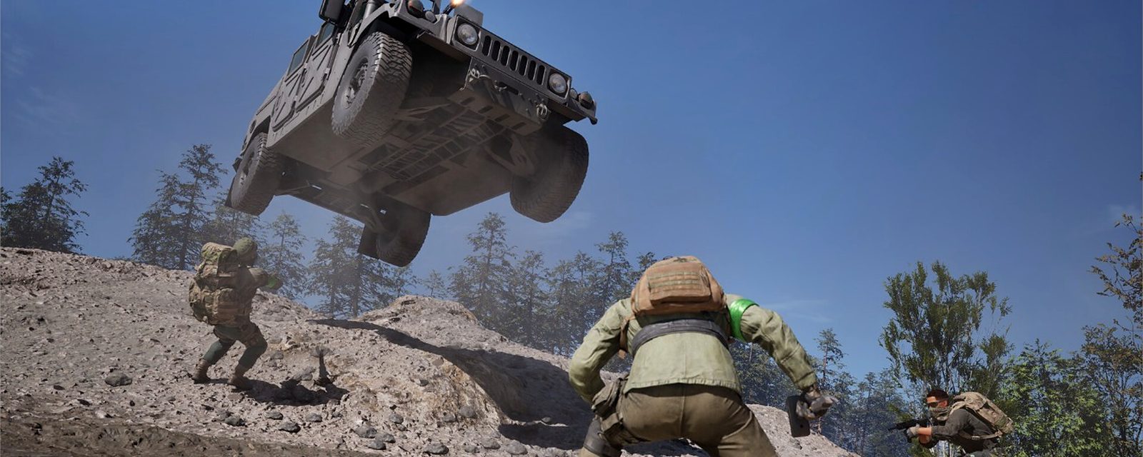 A WARDOGS armoured vehicle launching over a ridge
